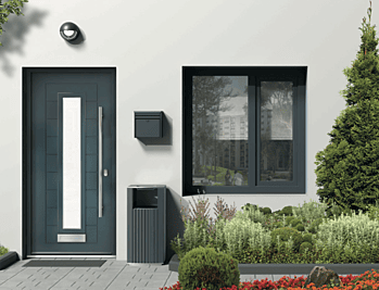 Contemporary Smart Signature aluminium composite door with vertical glazed panel and side light in modern grey exterior.